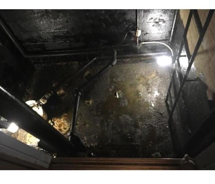 Stagnant water at the bottom of an elevator shaft.